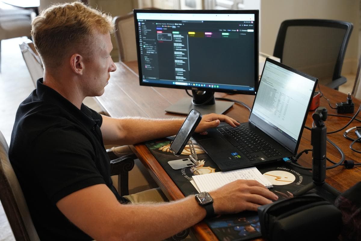 Rainer Jonker working on property listings at his desk with dual monitors and CRM system